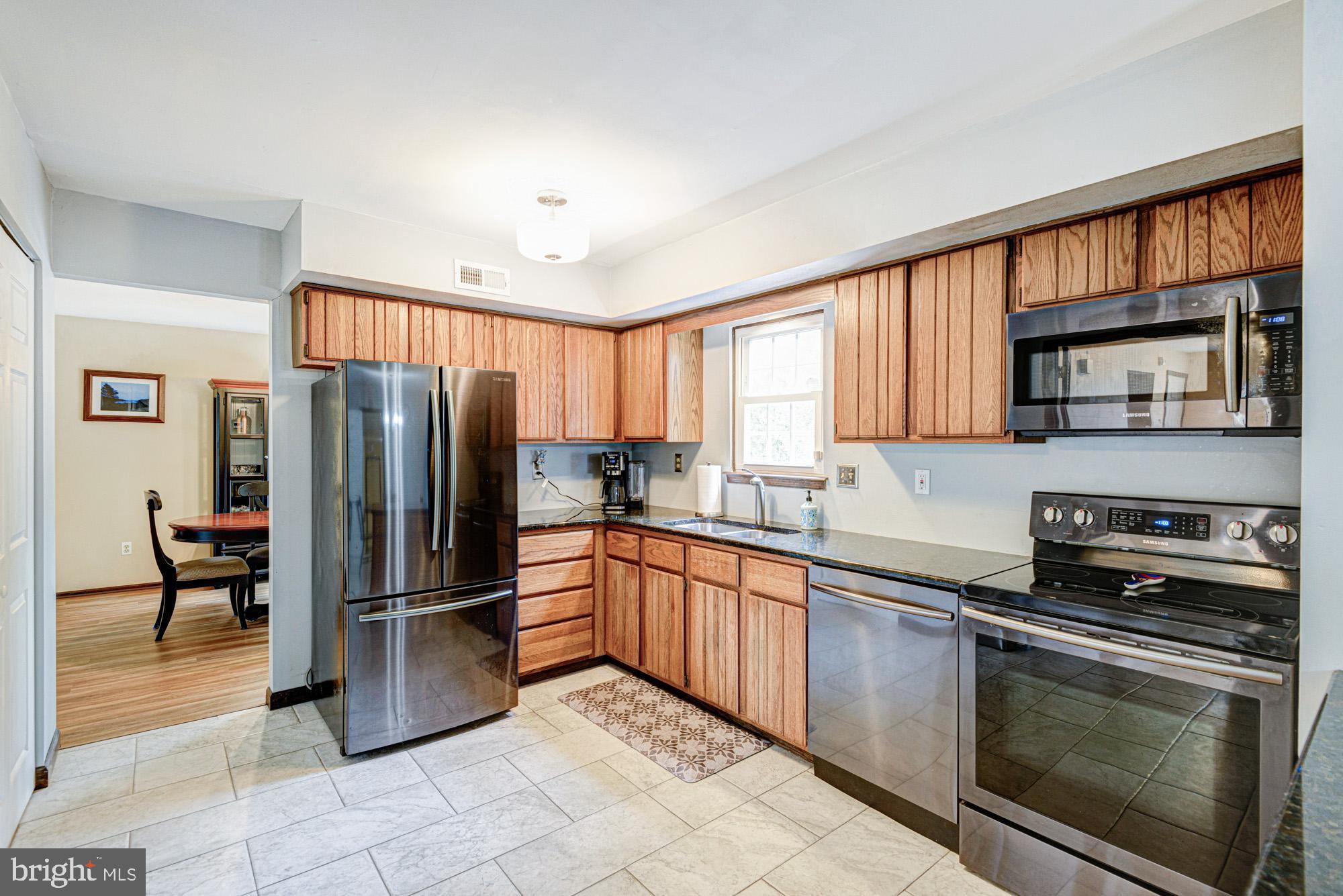 8 Risa Court Newark, DE 19702 - Photo 34 of 58 a kitchen with stainless steel appliances granite countertop a refrigerator stove and microwave