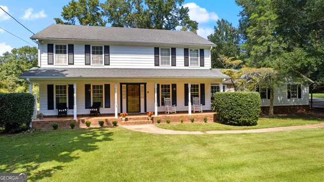 a front view of a house with a yard table and chairs