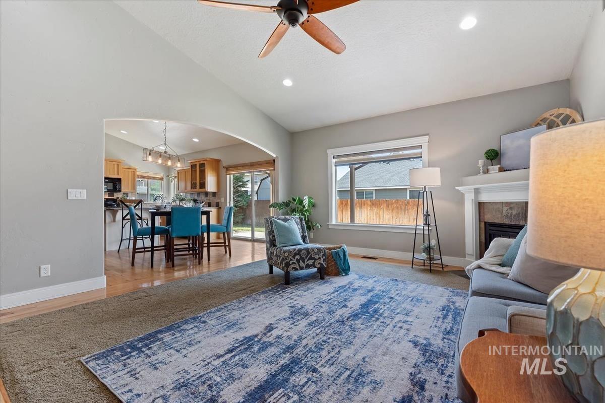 640 Southwest Miner Street Mountain Home, ID 83647 - Photo 26 of 35 Vaulted ceilings and recessed lighting enhance the living area, featuring a fireplace with a mantel and tile surround