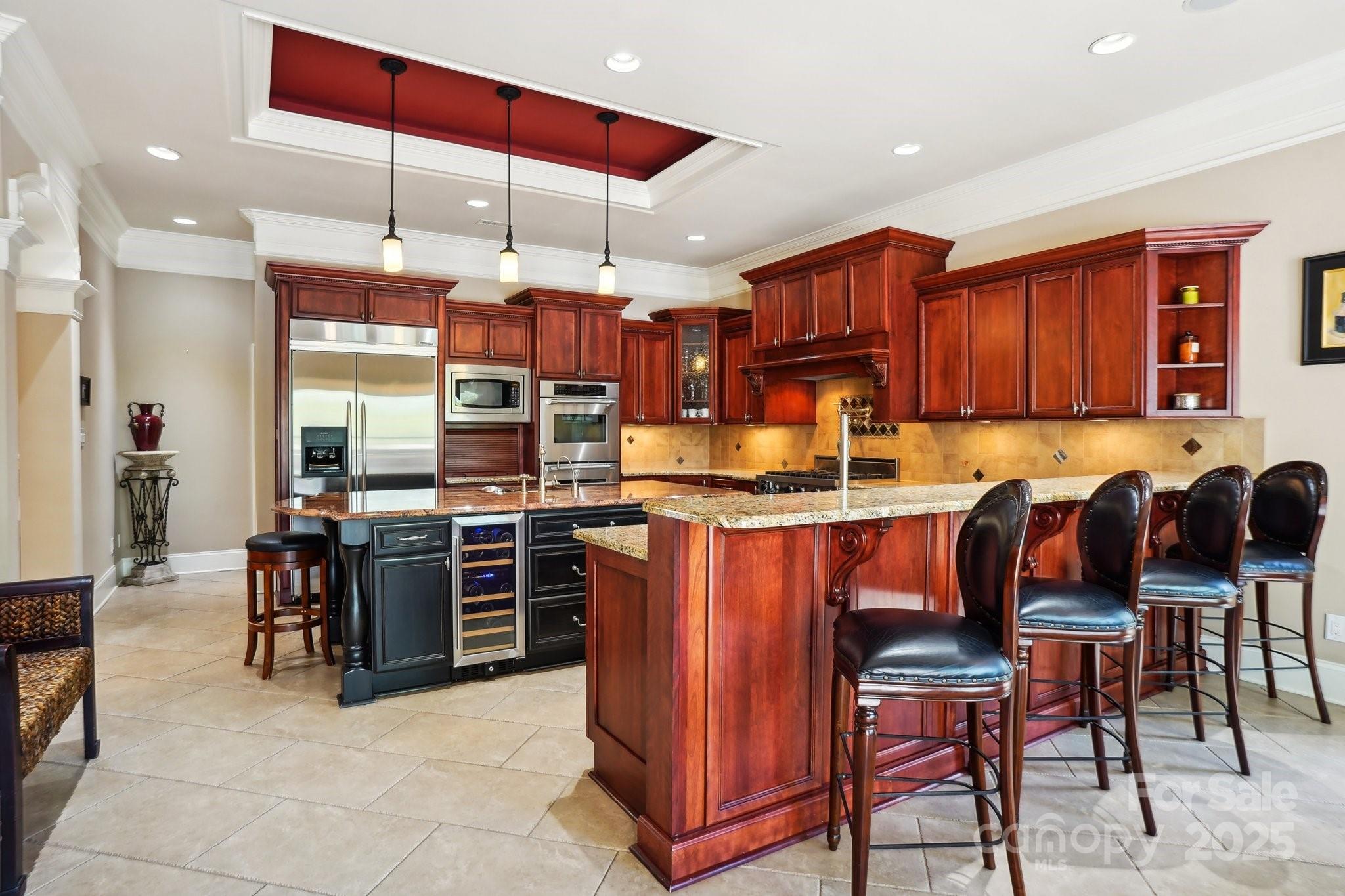 167 Maple View Drive Troutman, NC 28166 - Photo 12 of 48 a kitchen with lots of wooden cabinets a sink and appliances
