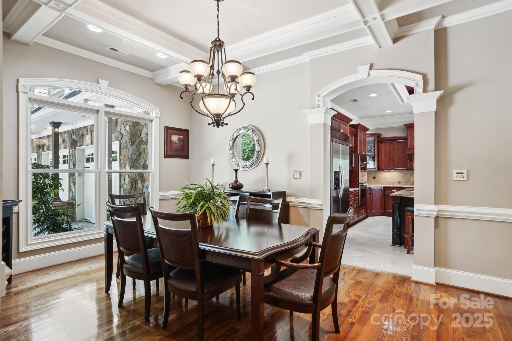 167 Maple View Drive Troutman, NC 28166 - Photo 16 of 48 a view of a dining room with furniture a chandelier and wooden floor