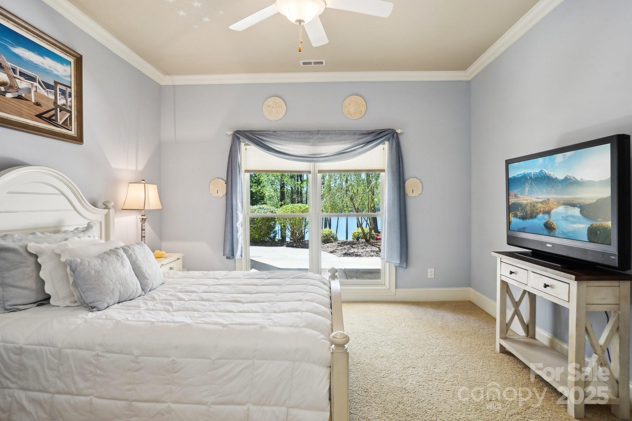 167 Maple View Drive Troutman, NC 28166 - Photo 30 of 48 a bedroom with a bed and a flat screen tv