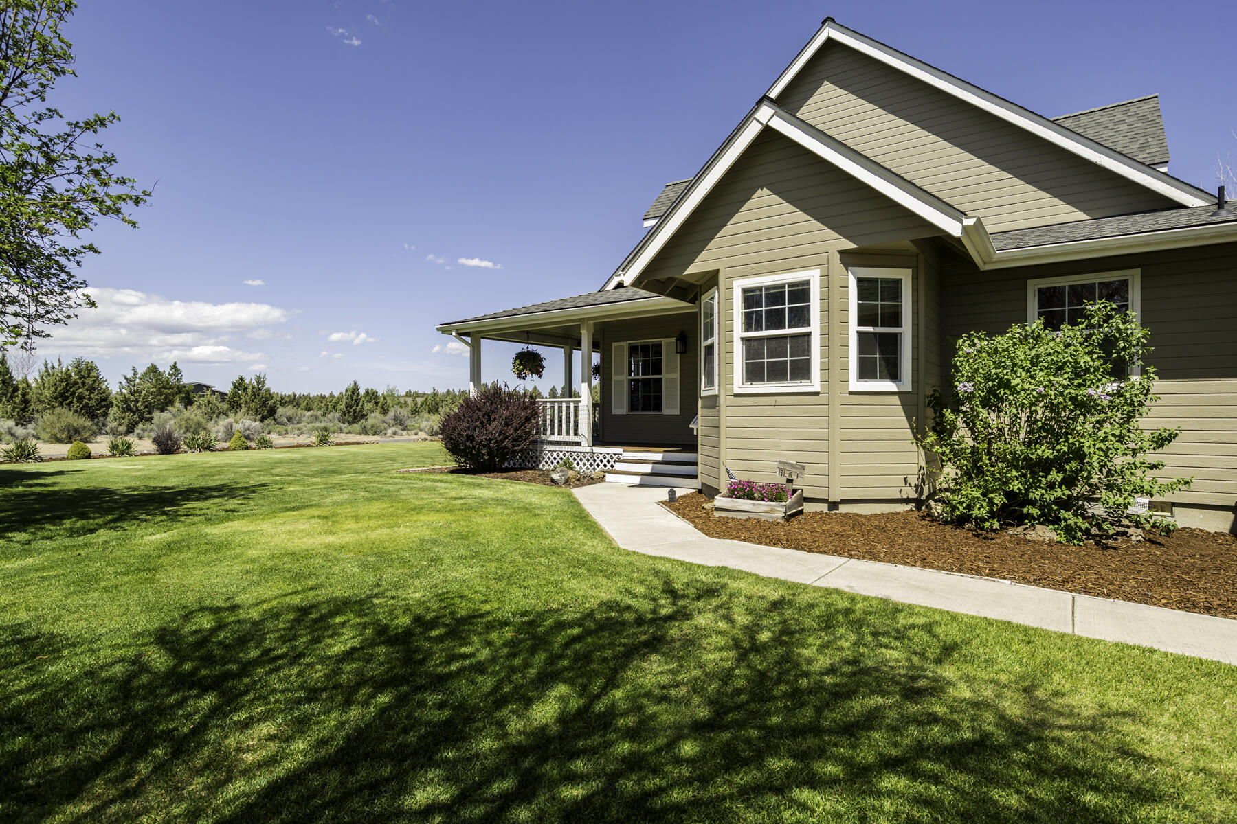 61030 Jennings Road Bend, OR 97702 - Photo 5 of 76 a front view of a house with yard and green space