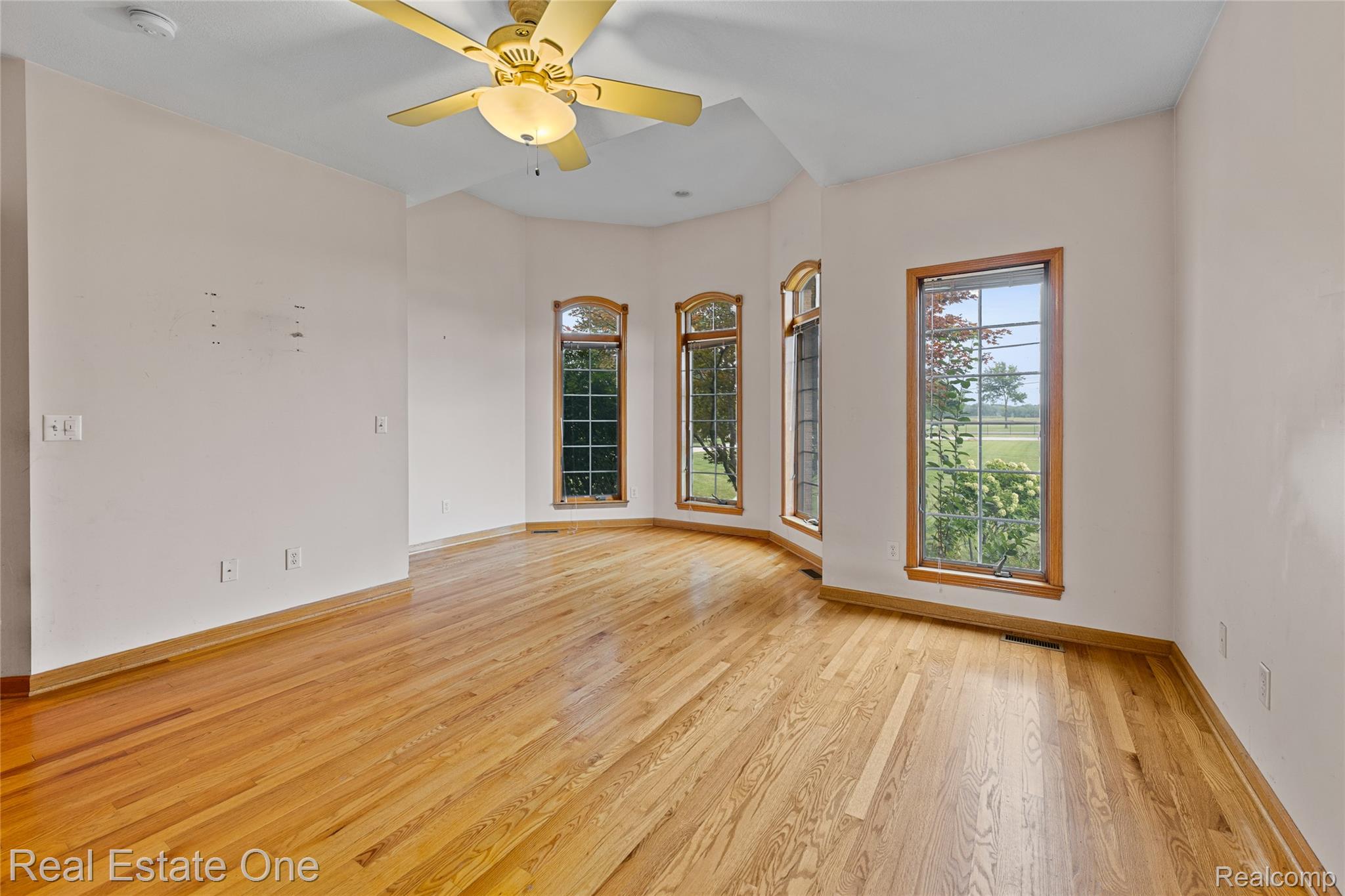 17268 Beech Daly Road Romulus, MI 48174 - Photo 34 of 60 Hardwood flooring, multiple windows, ceiling fan with integrated lighting, and neutral wall tones