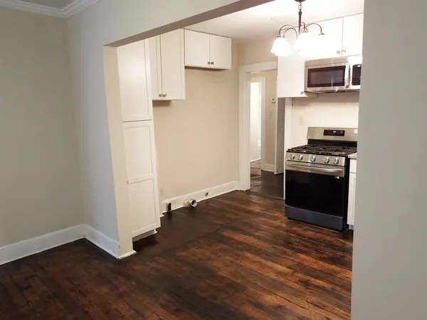 a kitchen with granite countertop a stove and a refrigerator
