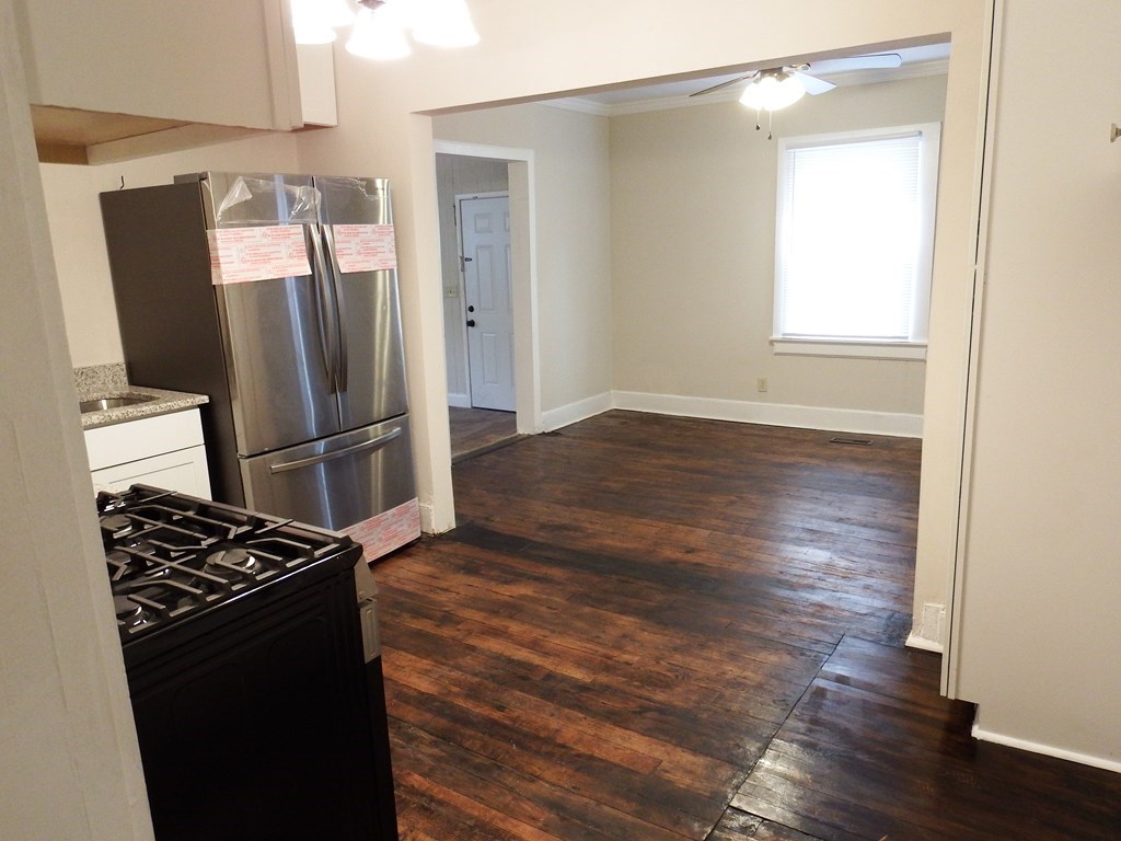 2211 Tillman Street Columbus, GA 31906 - Photo 13 of 20 a kitchen with wooden floor and a refrigerator