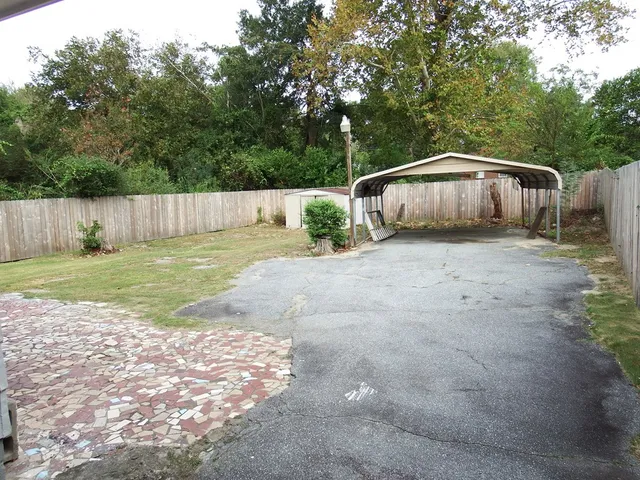 a backyard of a house with table and chairs