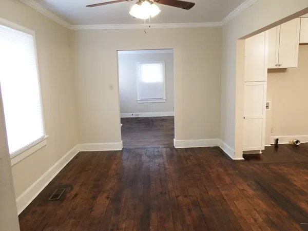 wooden floor in an empty room with a window