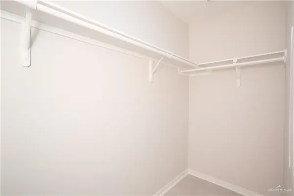 an empty room with a ceiling fan and a window