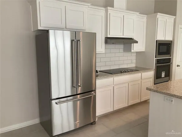 a kitchen with a refrigerator and cabinets