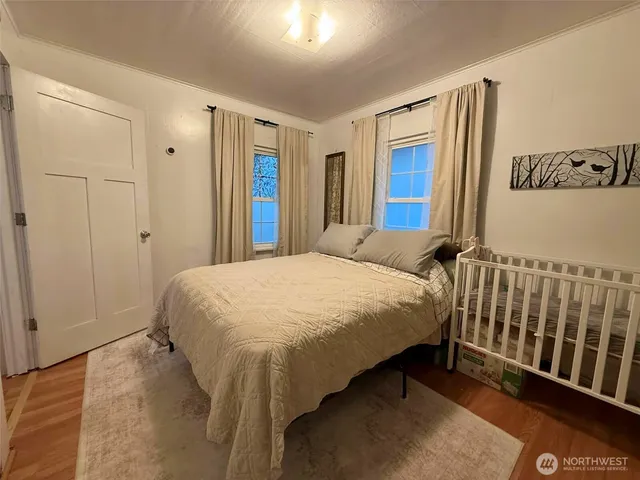 a bed sitting in a bedroom next to a window