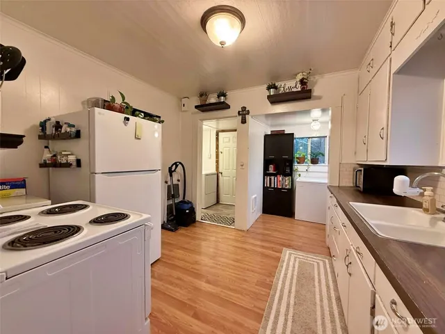 a kitchen with refrigerator and cabinets