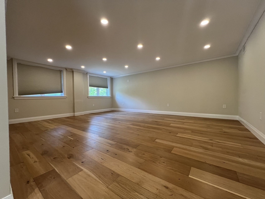 23 Winslow Road, Unit 1 Brookline, MA 02446 - Photo 17 of 27 a view of empty room with wooden floor