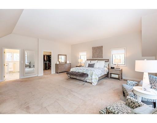 51 Townsend Farm Road Boxford, MA 01921 - Photo 22 of 30 a spacious bedroom with a bed a table and painting