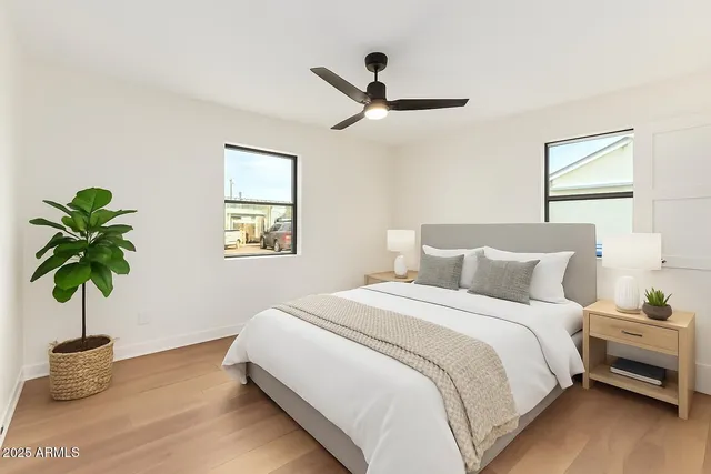 a bedroom with a bed and a potted plant