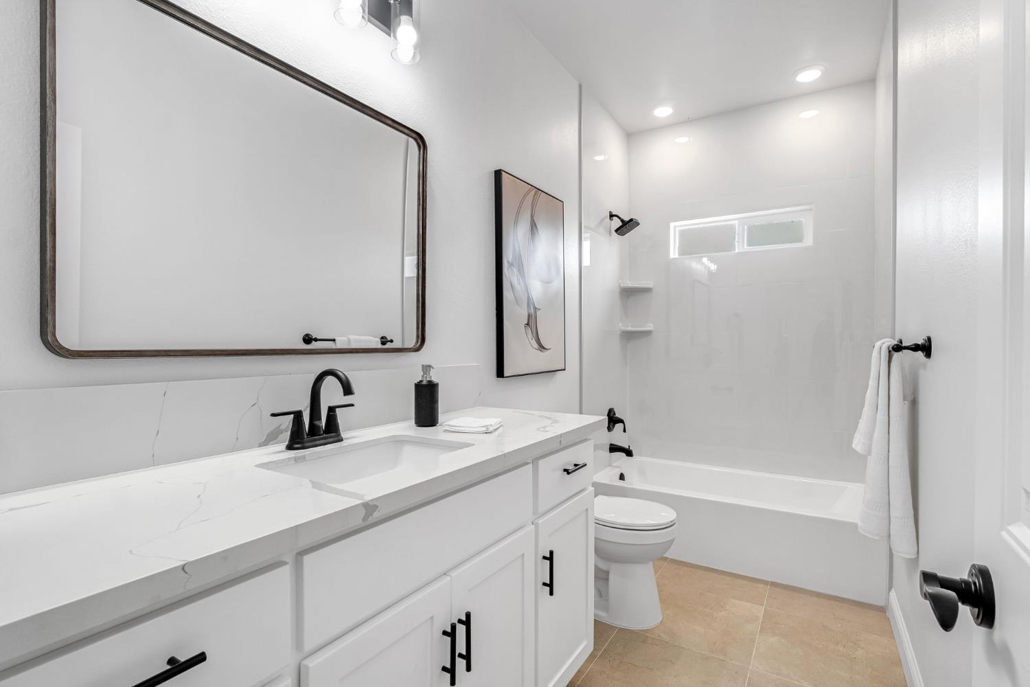 21035 Forest Glen Road Madera, CA 93638 - Photo 27 of 38 a bathroom with a double vanity sink toilet mirror and shower