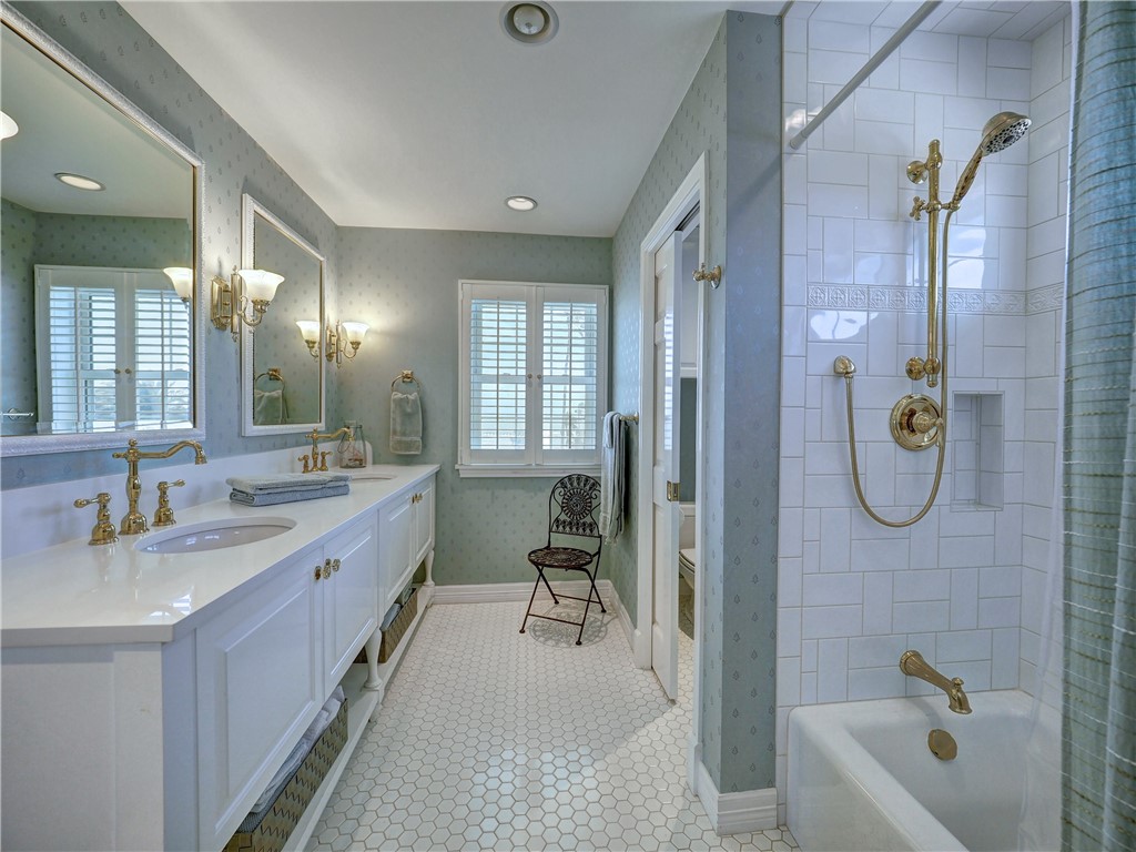 334 Pebble Beach Drive Portland, TX 78374 - Photo 36 of 40 a bathroom with a granite countertop tub sink and mirror