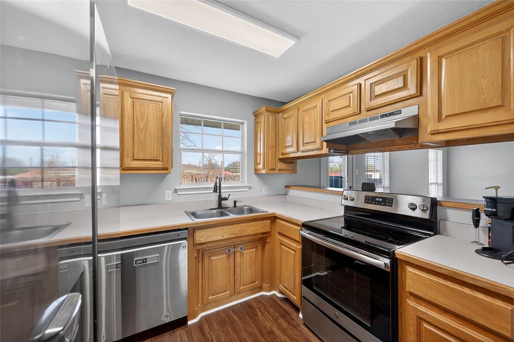 420 Robert Drive Springtown, TX 76082 - Photo 11 of 38 a kitchen with stainless steel appliances granite countertop a sink stove and cabinets