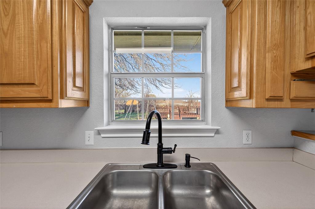 420 Robert Drive Springtown, TX 76082 - Photo 12 of 38 a kitchen with stainless steel appliances a sink and a window
