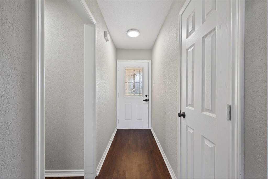 420 Robert Drive Springtown, TX 76082 - Photo 13 of 38 a view of a hallway with a wooden floor