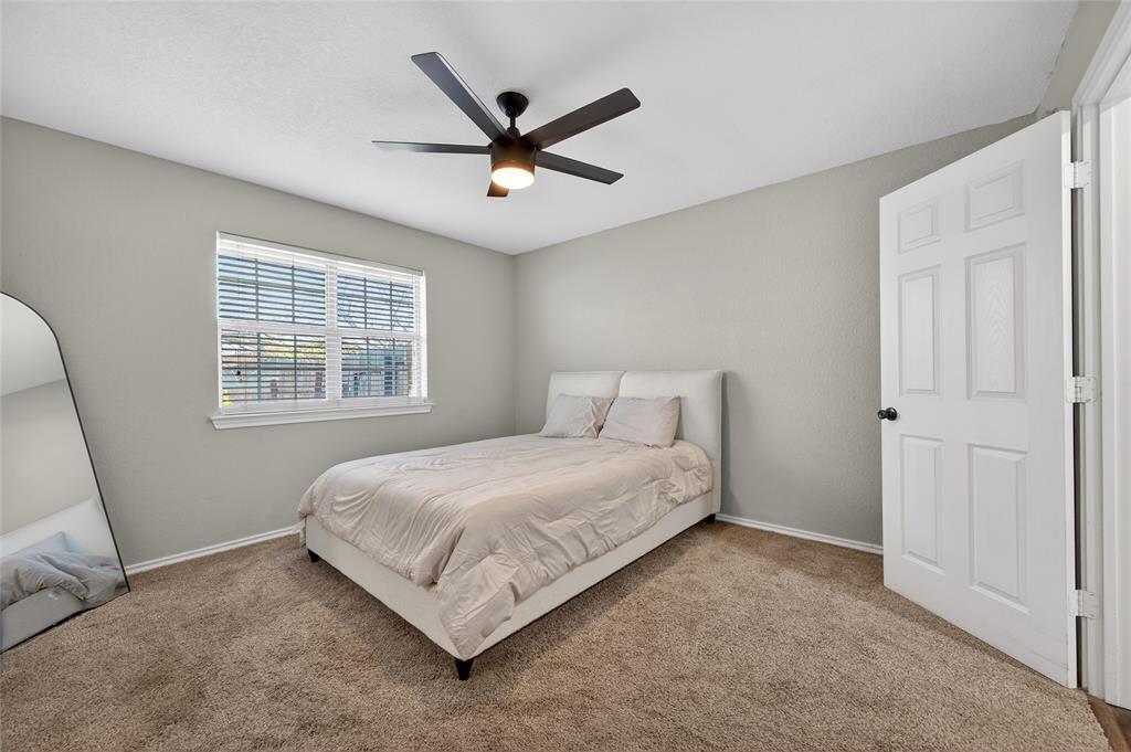 420 Robert Drive Springtown, TX 76082 - Photo 14 of 38 a bedroom with a bed and a window