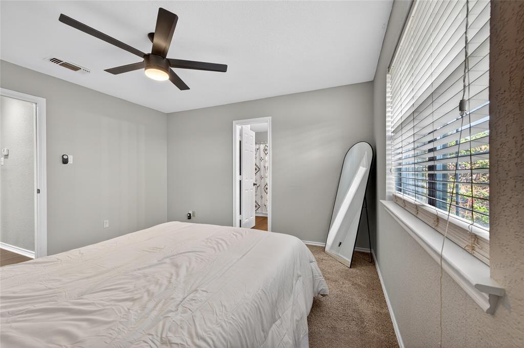 420 Robert Drive Springtown, TX 76082 - Photo 15 of 38 a bedroom with a bed and a large window