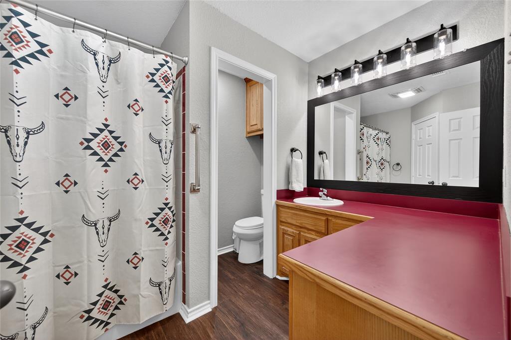 420 Robert Drive Springtown, TX 76082 - Photo 16 of 38 a bathroom with a granite countertop sink and a mirror