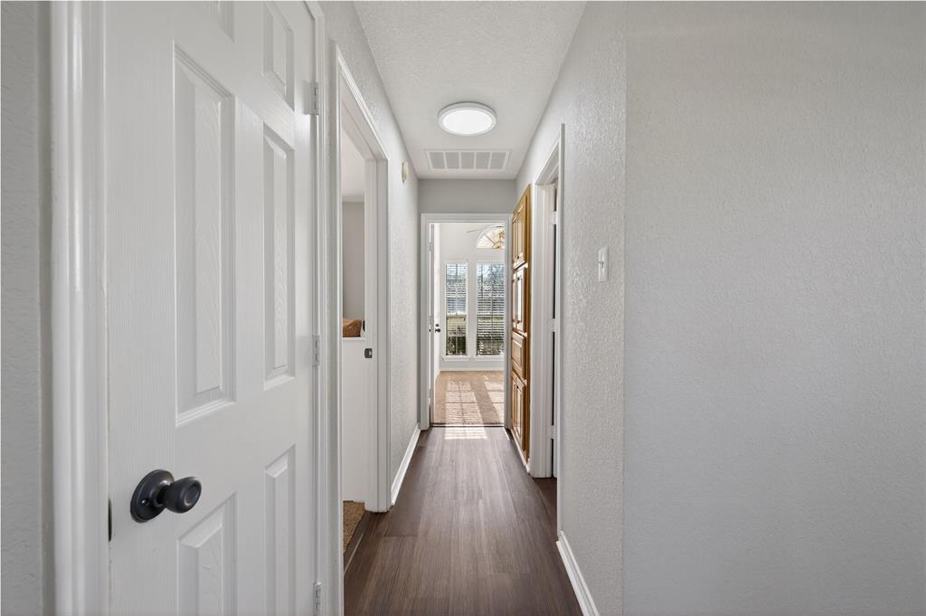 420 Robert Drive Springtown, TX 76082 - Photo 17 of 38 a view of a hallway with wooden floor