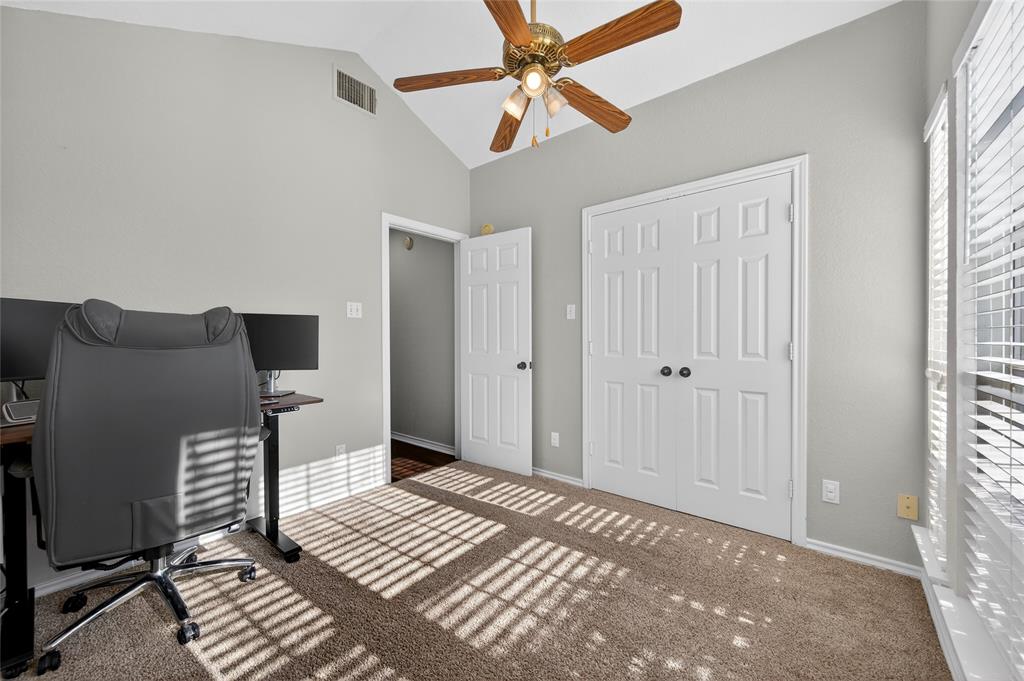 420 Robert Drive Springtown, TX 76082 - Photo 21 of 38 a view of a bedroom with wooden floor fan and windows