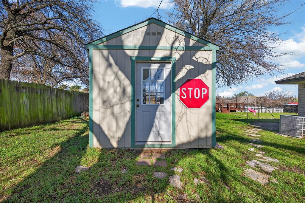 420 Robert Drive Springtown, TX 76082 - Photo 24 of 38 a view of outdoor space with sign board and garden
