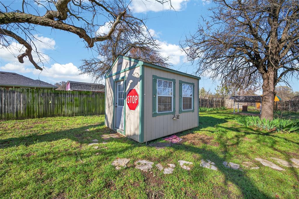 420 Robert Drive Springtown, TX 76082 - Photo 26 of 38 a front view of a house with garden