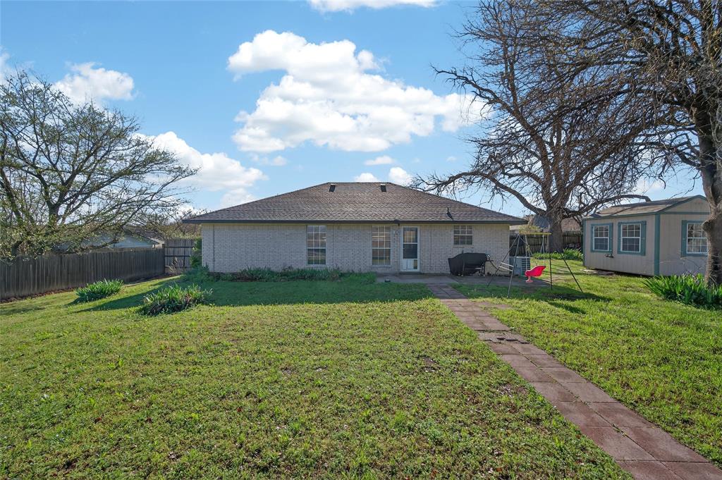 420 Robert Drive Springtown, TX 76082 - Photo 27 of 38 a front view of a house with garden