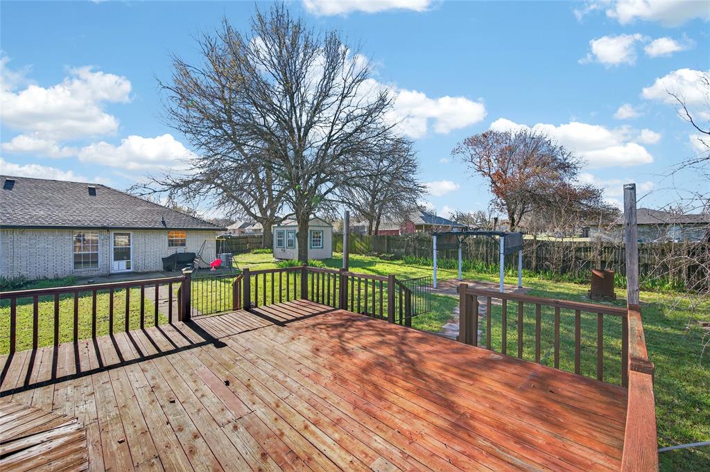 420 Robert Drive Springtown, TX 76082 - Photo 31 of 38 a view of a wooden deck with a yard