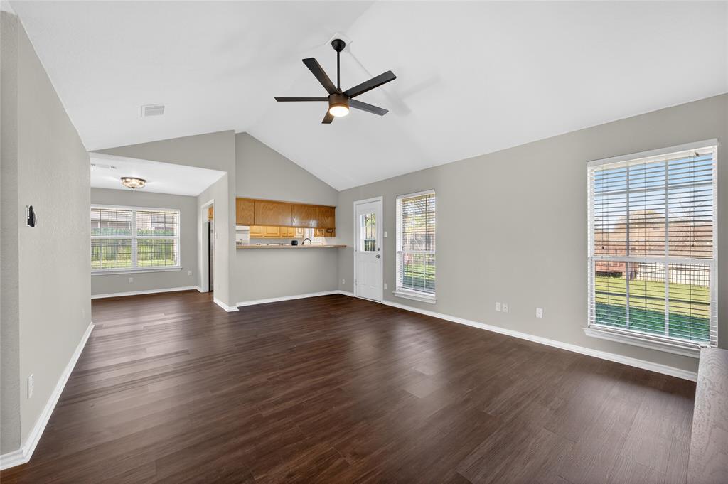 420 Robert Drive Springtown, TX 76082 - Photo 8 of 38 a view of a livingroom with wooden floor a ceiling fan and windows