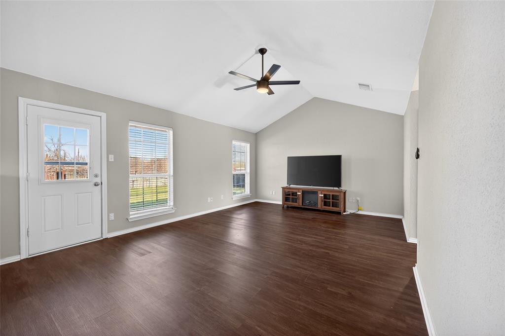 420 Robert Drive Springtown, TX 76082 - Photo 9 of 38 a view of a livingroom with wooden floor and a ceiling fan