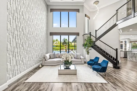 a view of a dining room with furniture a chandelier and wooden floor