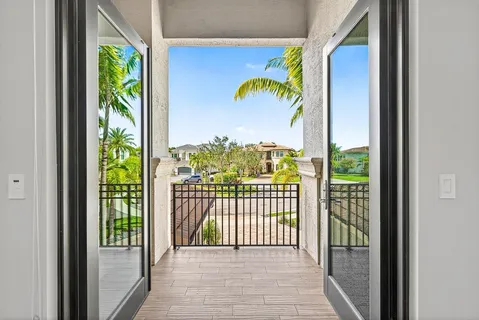 an aerial view of a house with a garden and lake view