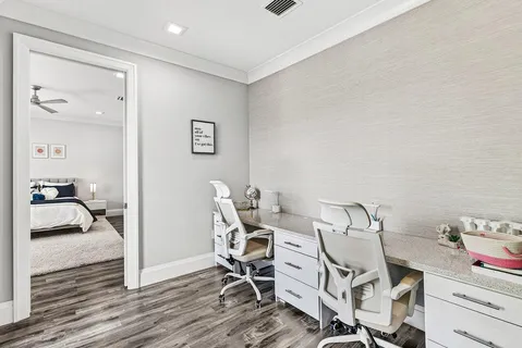 an aerial view of a house with a garden and lake view