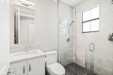 an aerial view of residential houses with outdoor space and swimming pool