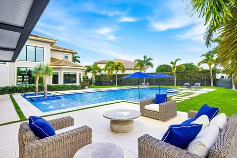 a living room with furniture a pool table and a large window