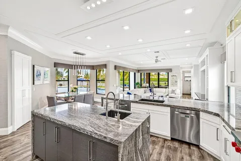 a dining room with furniture a chandelier and wooden floor