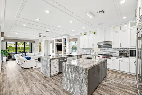 a view of swimming pool with lawn chairs under an umbrella