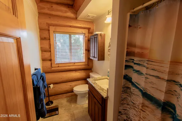 a bathroom with a toilet sink and shower