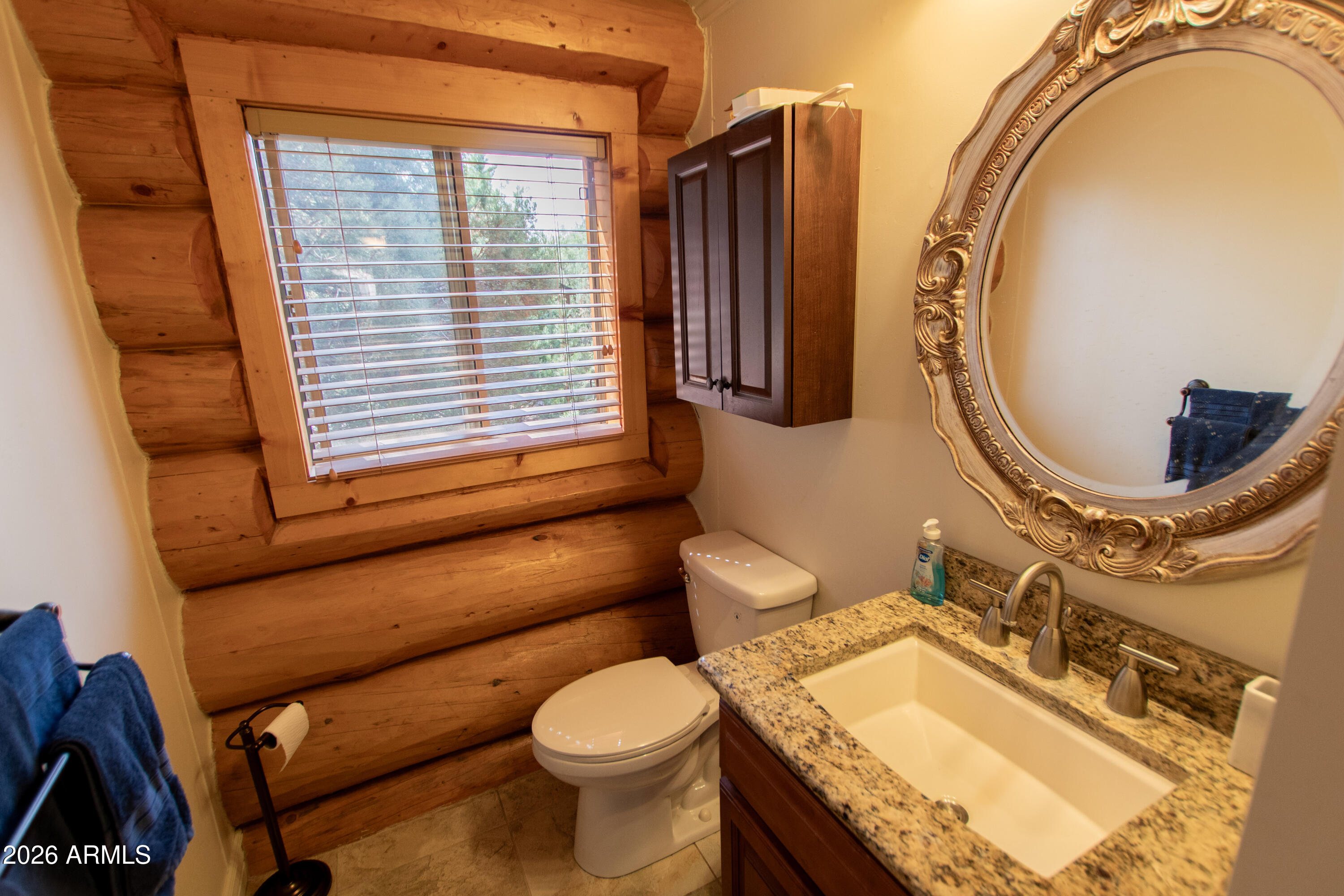 6168 Hidden Pines Loop Pine, AZ 85544 - Photo 15 of 25 a bathroom with a granite countertop toilet sink and mirror