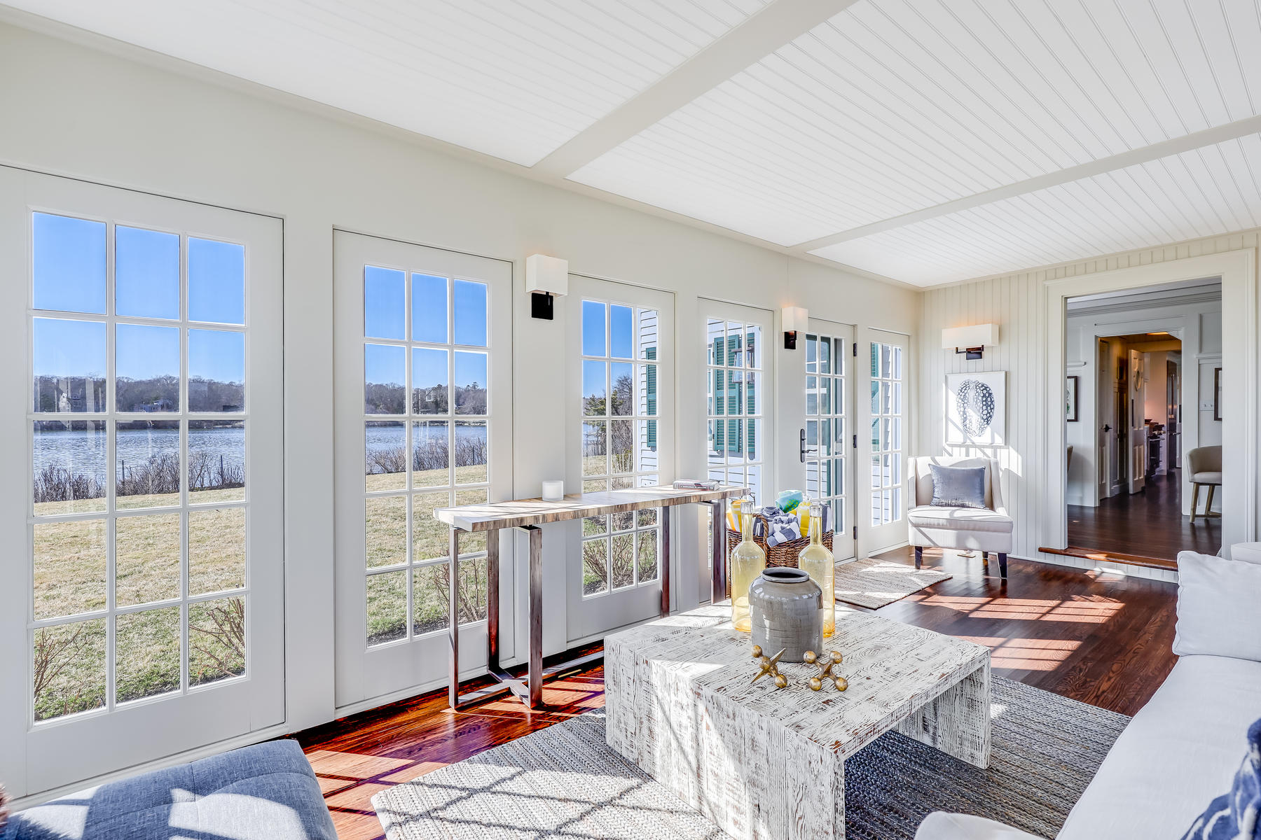 67 Quonset Road Falmouth, MA 02540 - Photo 13 of 55 a living room with furniture kitchen view and large windows