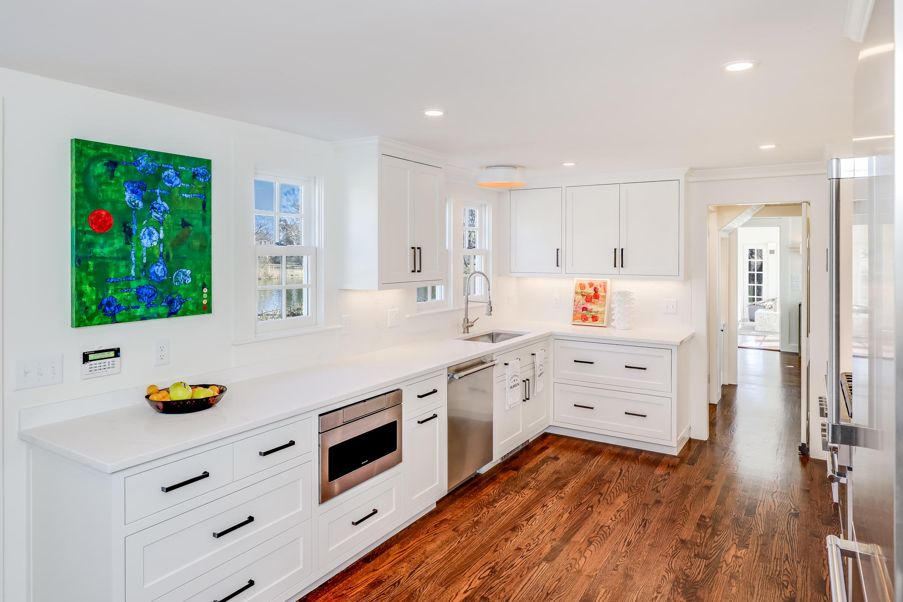 67 Quonset Road Falmouth, MA 02540 - Photo 19 of 55 a kitchen with stainless steel appliances cabinets and wooden floor