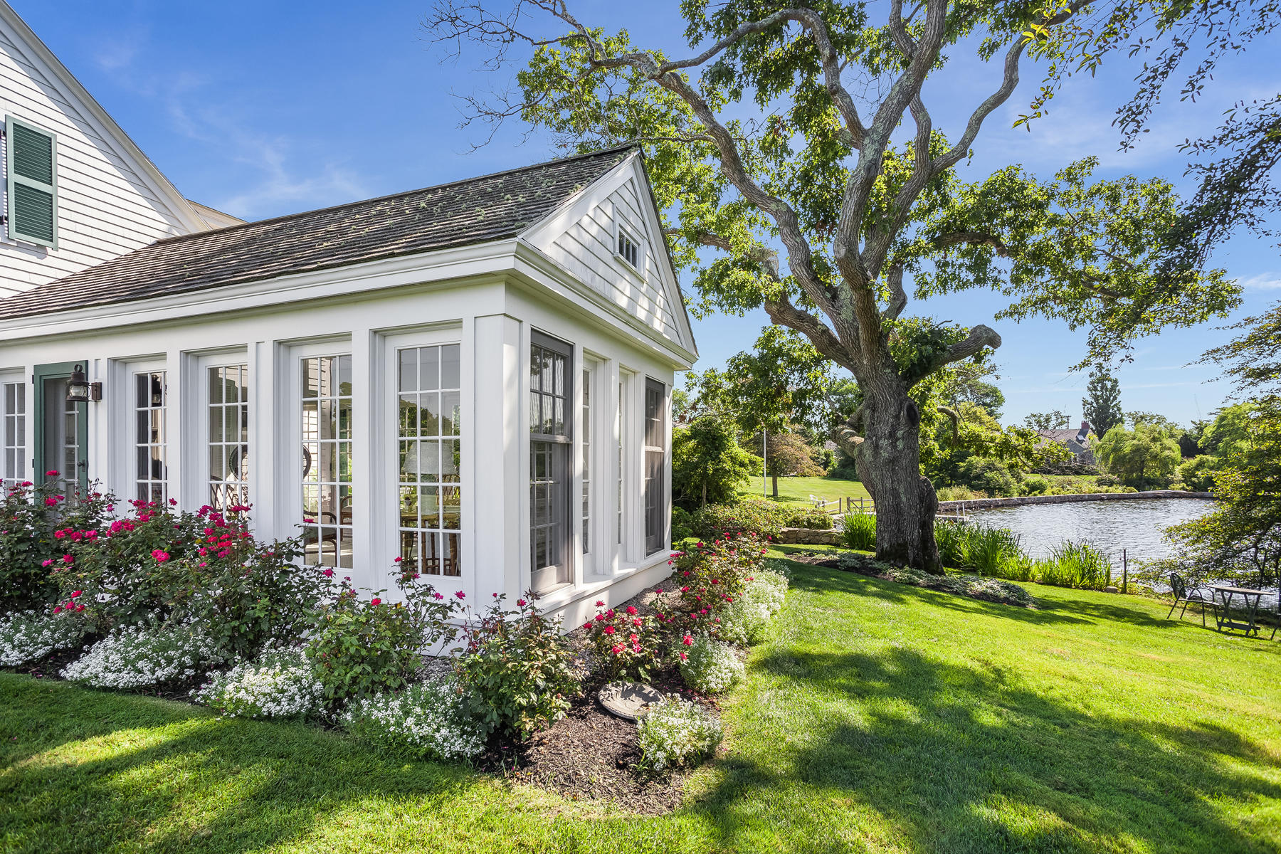 67 Quonset Road Falmouth, MA 02540 - Photo 4 of 55 a view of a house with garden and a tree