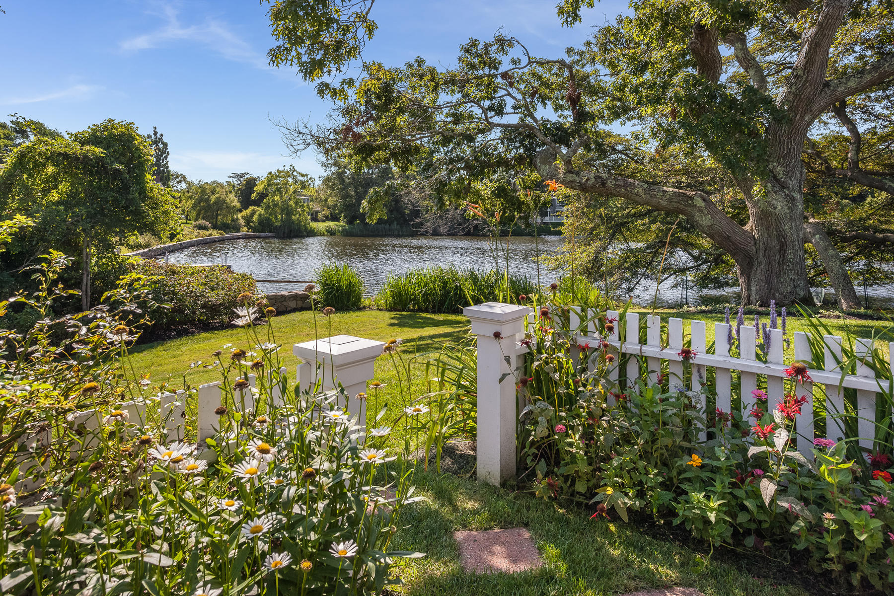 67 Quonset Road Falmouth, MA 02540 - Photo 42 of 55 a view of a lake with a house in the background