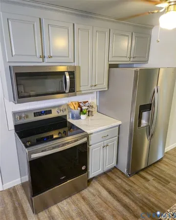 a kitchen with cabinets and steel stainless steel appliances