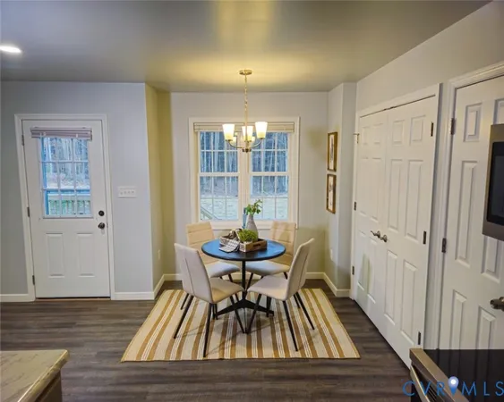 a dining room with furniture and wooden floor